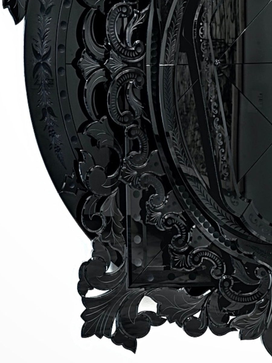 Corner of large, multi-layered mirror and frame made of black glass