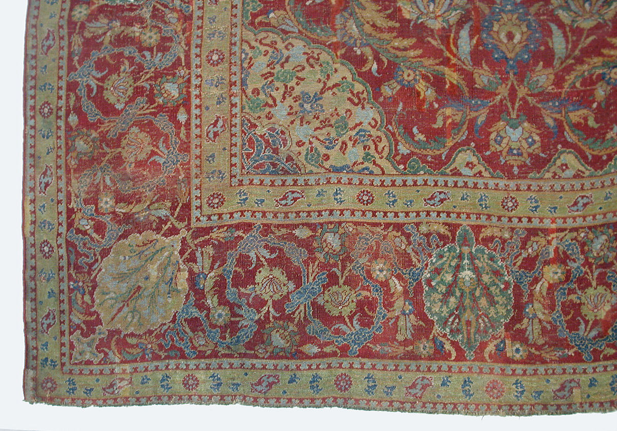 Detail of a red, yellow, green, and blue carpet with vegetal and floral motifs