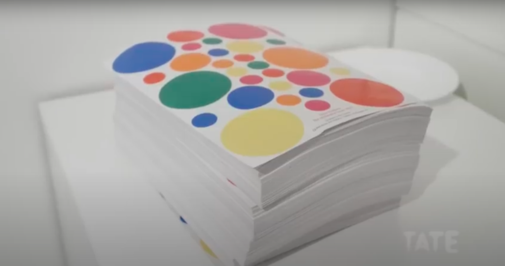 A detail of the 28-sticker sheet used at the Tate Modern's Obliteration Room. The sheet has red, orange, yellow, green, blue, and pink circular stickers.