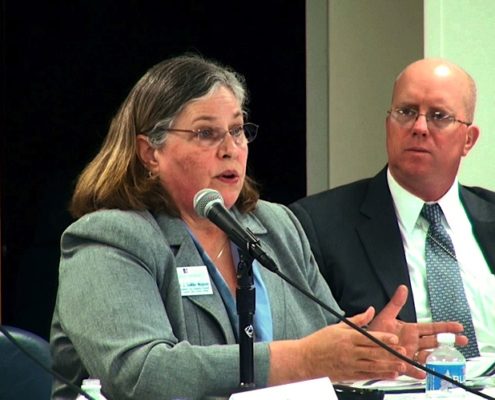 woman speaking behind microphone