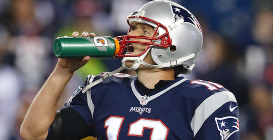 Patriots Quarterback, Tom Brady, drinking out of a Gatorade bottle