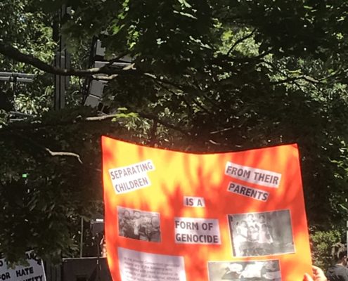 A poster at the Keep Families Together Rally in Washington, DC, 2018. The poster reads "Separating children from their parents is a form of genocide"