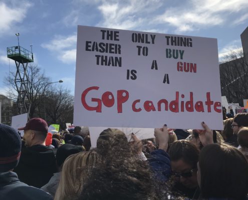 A poster at the March for Our Lives Rally in Washington, DC, 2018. The poster reads "The only thing easier to buy than a gun is a GOP candidate"