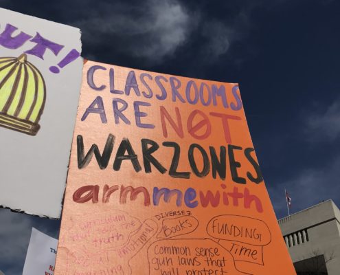 A poster at the March for Our Lives Rally in Washington, DC, 2018. The poster reads "Classrooms are not warzones. Arm me with love"