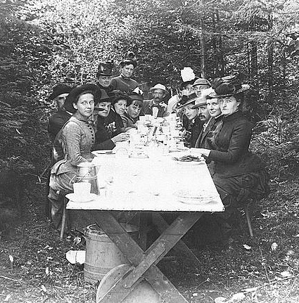 people sitting at picnic table